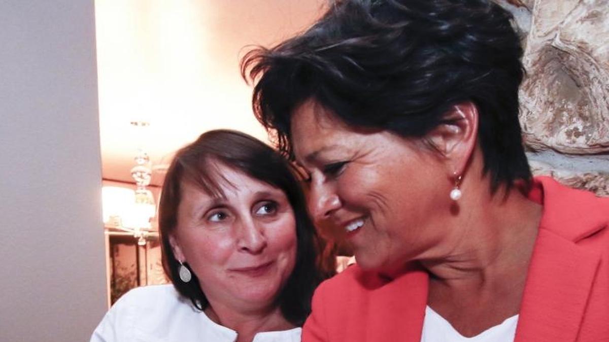 Maria Kelly, left, talks Dawn Ortiz-Legg about election returns June 7.