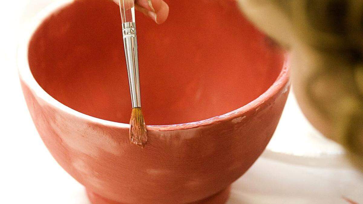A ceramic bowl is decorated for the “Empty Bowls” event to benefit the 5Cities Homeless Coalition.