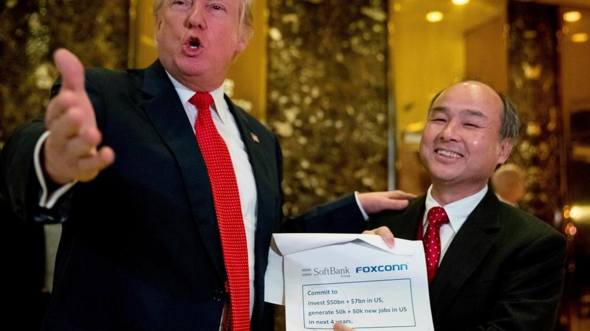President-elect Donald Trump, left, accompanied by SoftBank CEO Masayoshi Son, speaks to members of the media at Trump Tower in New York on Dec. 6.