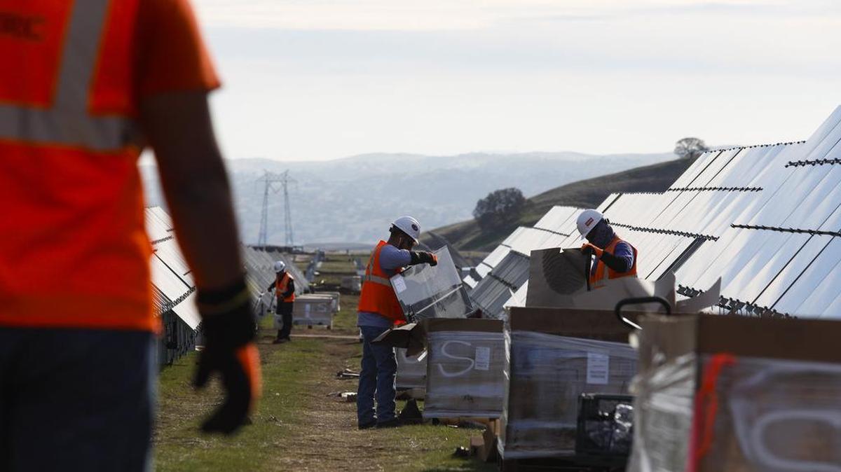 Workers install solar panels on Highway 41, east of Cholame.