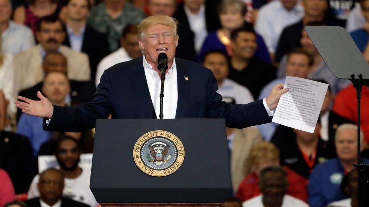 President Donald Trump gestures as he holds up a piece of paper during a campaign rally Saturday, Feb. 18, 2017, in Melbourne, Fla.