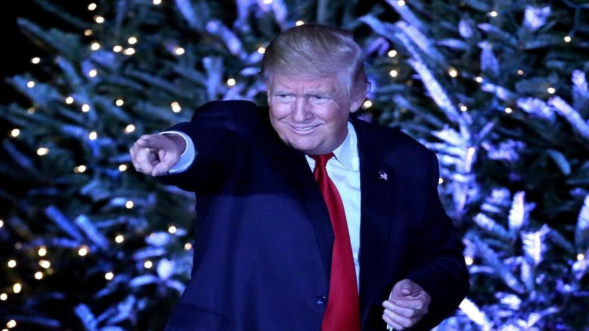 President-elect Donald Trump responds to cheering supporters in front of a Christmas-themed backdrop at a rally in Orlando, Fla., on Friday, Dec. 16, 2016.