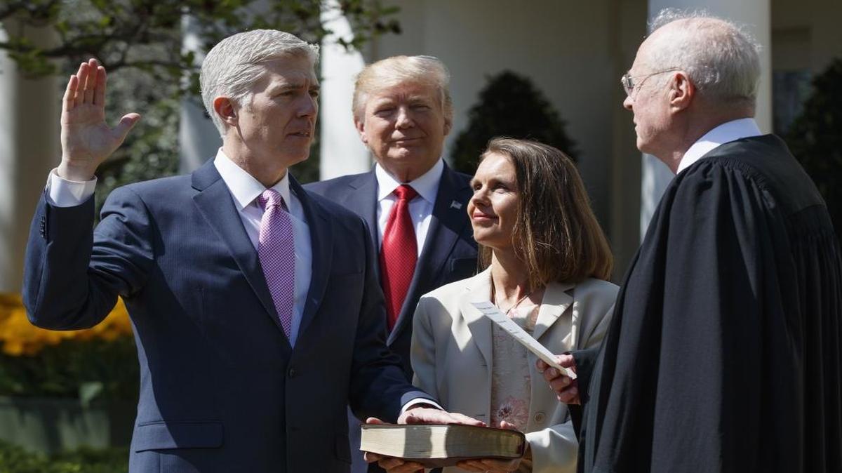President Donald Trump watches as Supreme Court Justice Anthony Kennedy administers the judicial oath to Justice Neil Gorsuch, accompanied by his wife Marie Louise, during a public swearing-in ceremony in the Rose Garden of the White House in Washington Monday, April 10, 2017.