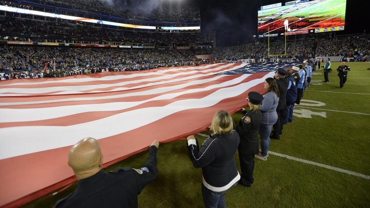 An American flag is presented before an NFL football game between the Tennessee Titans and the Indianapolis Colts Monday, Oct. 16, 2017, in Nashville, Tenn.