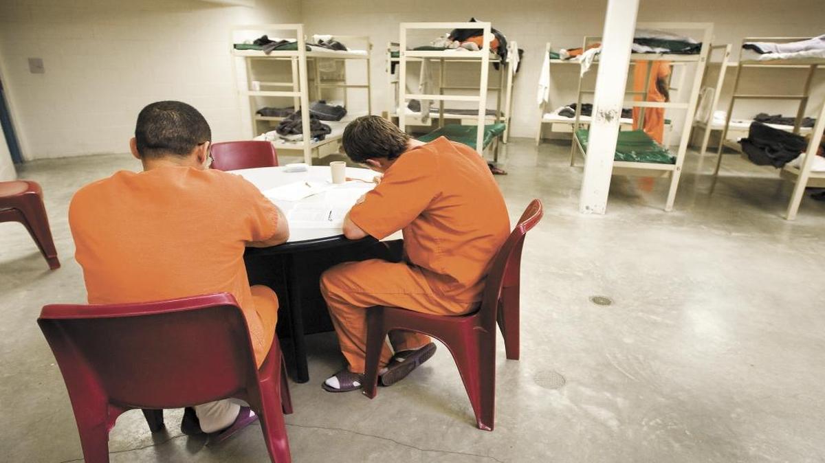 Inmates sit inside a dorm at San Luis Obispo County Jail.
