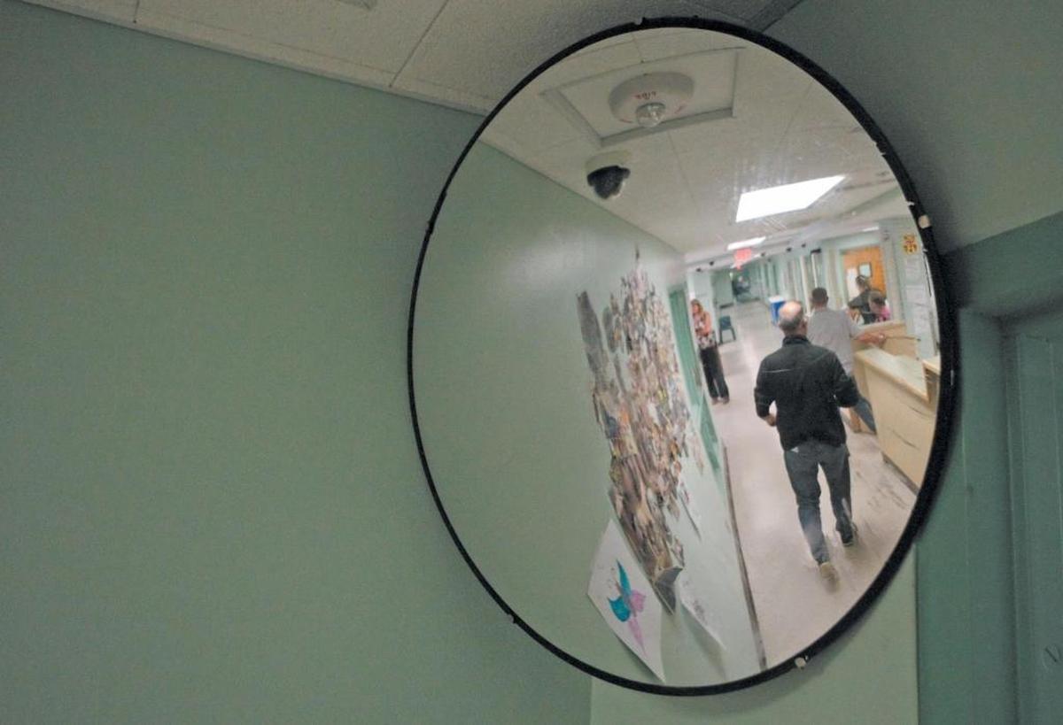 Staffers walk in the adult residential hallway at the SLO County Psychiatric Health Facility, commonly known as the “Puff.”