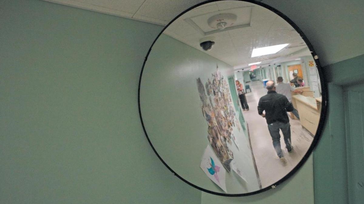 Staffers walk in the adult residential hallway at the SLO County Psychiatric Health Facility.