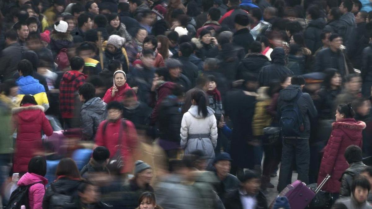 People rush to catch their train at Beijing station in Beijing to return home for the Chinese lunar new year in 2012. China is increasingly becoming a nation of town and city dwellers, with more than 55 percent now living in urban areas, the government said.