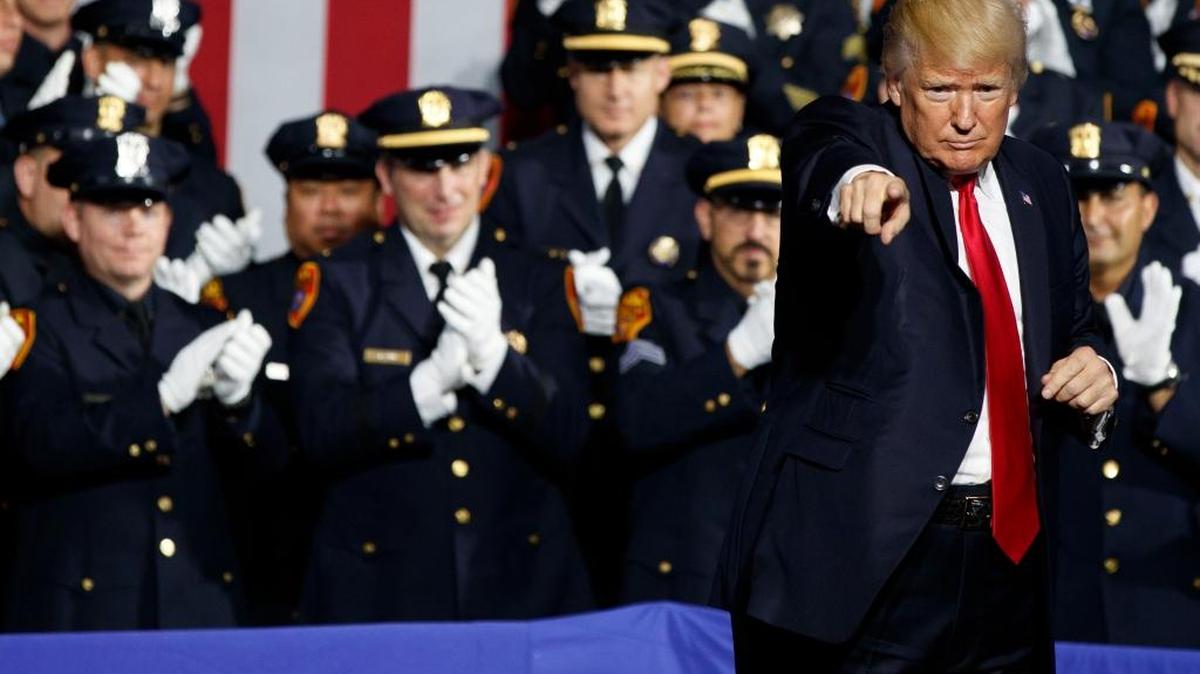 President Donald Trump points to the crowd after speaking to law enforcement officials on the street gang MS-13, Friday, July 28, 2017, in Brentwood, N.Y.