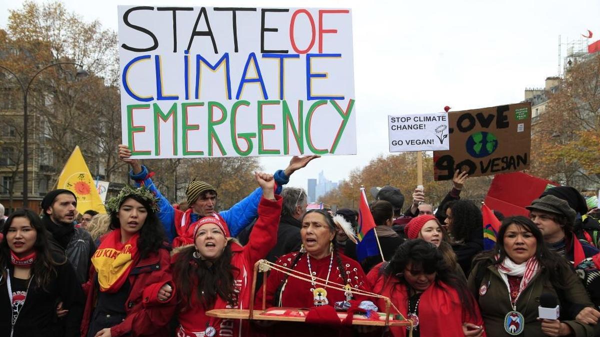 Climate activists demonstrate in Paris, Saturday, Dec.12, 2015 during the COP21, the United Nations Climate Change Conference. Several environmental and human rights groups were planning protests around Paris to call attention to populations threatened by man-made global warming and urge an end to human use of oil, gas and coal.
