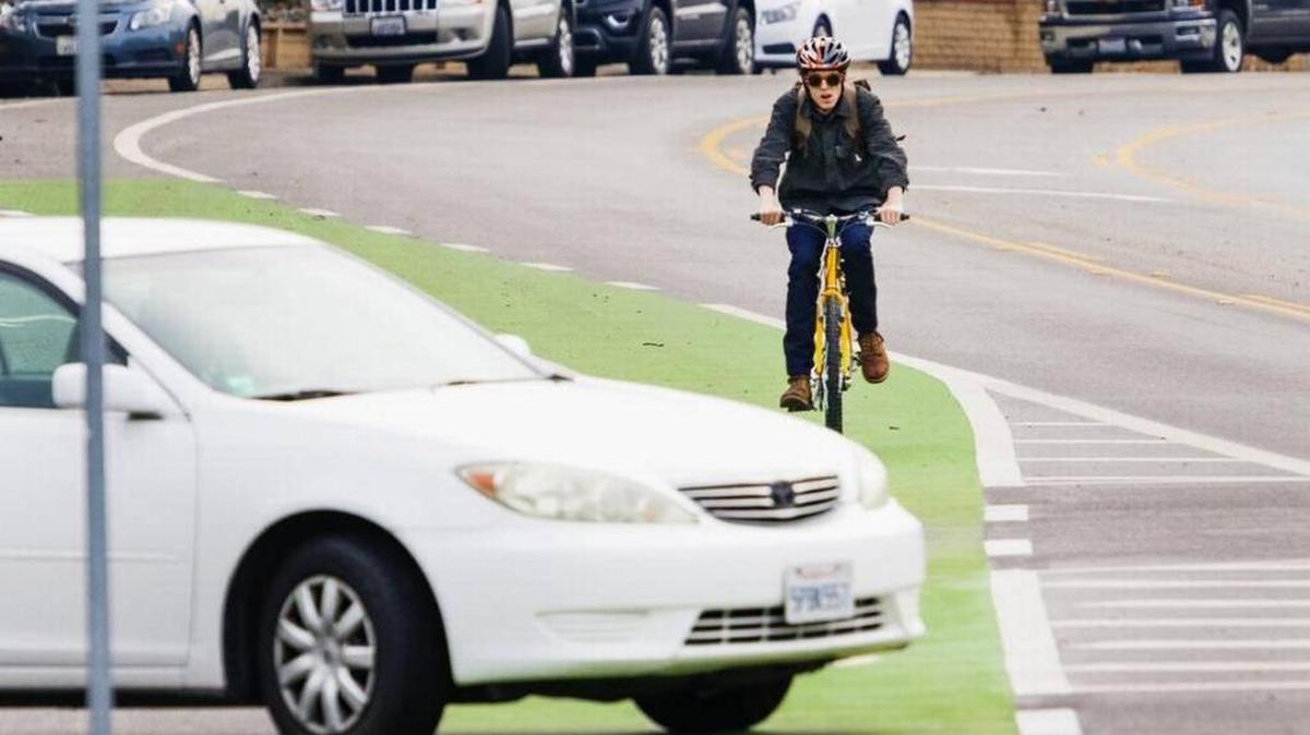 A cyclist bikes toward Cal Poly in the green bike lane along California Boulevard in 2016