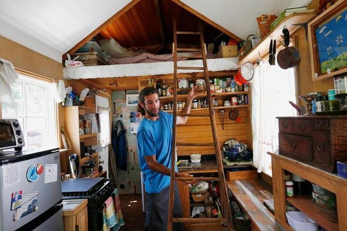 Tiny homes could have a big impact in a state like California where affordability is a major issue. Here, Aaron Castle uses a ladder to reach the sleeping area in his 139-square-foot tiny house on wheels in San Bruno.