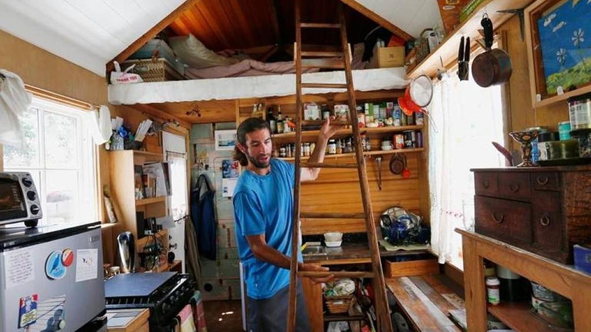 Tiny homes could have a big impact in a state like California where affordability is a major issue. Here, Aaron Castle uses a ladder to reach the sleeping area in his 139-square-foot tiny house on wheels in San Bruno.