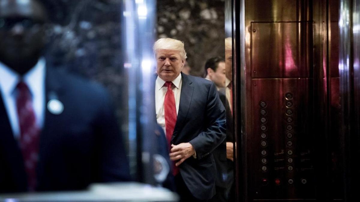 President-elect Donald Trump boards an elevator after speaking with the media at Trump Tower in New York, Tuesday, Dec. 6, 2016.