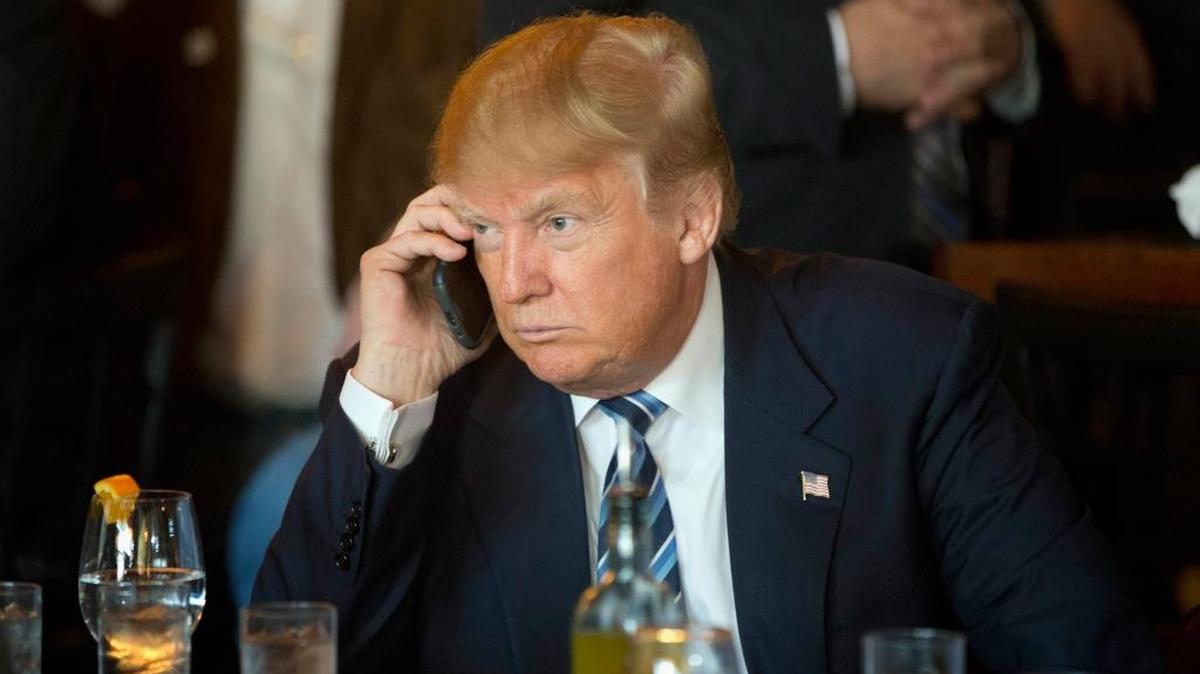 Republican presidential candidate Donald Trump listens to his mobile phone during a lunch stop in North Charleston, S.C., in February.