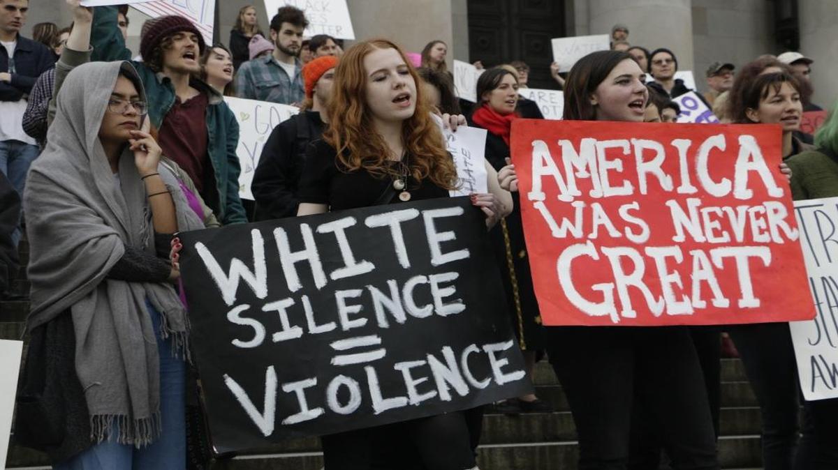 Protesters gather on the steps of the state Capitol in Olympia, Wash., in opposition of President-elect Donald Trump, on Friday, Nov. 11, 2016.