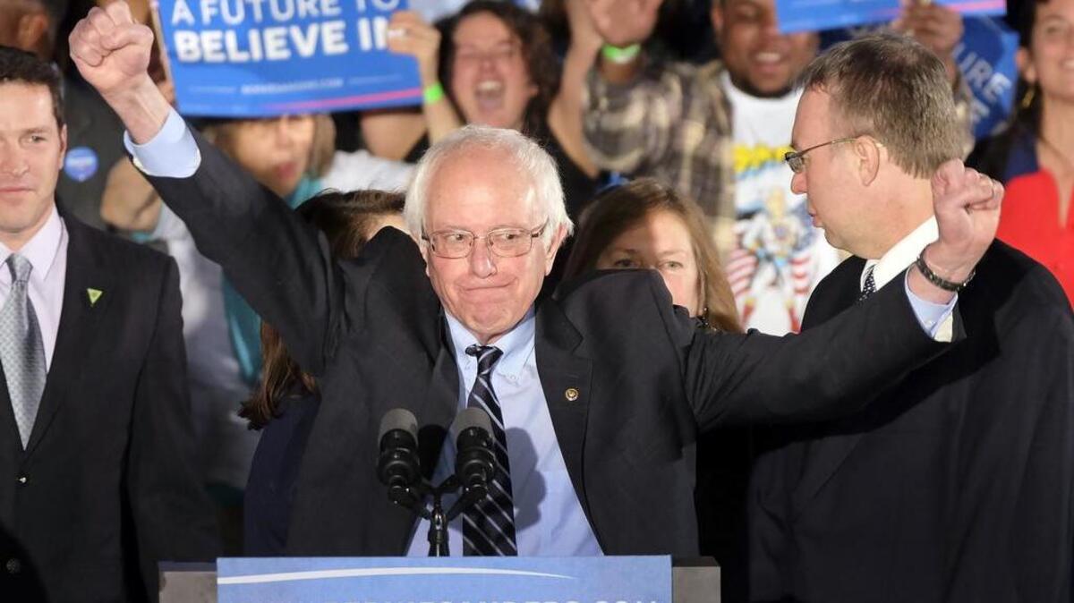 Democratic presidential candidate Sen. Bernie Sanders, I-Vt., reacts to the cheering crowd at his primary night rally Tuesday, Feb. 9, in Manchester, N.H.