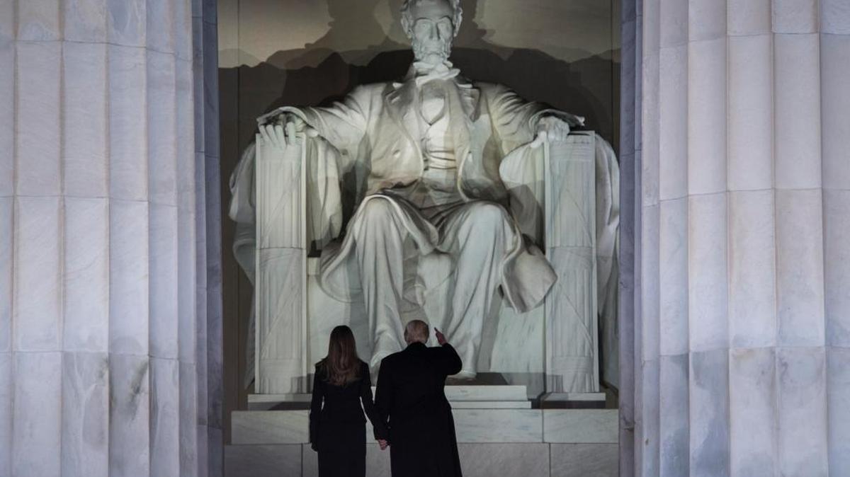 President-elect Donald Trump and his wife, Melania Trump, stand before the Lincoln Memorial.