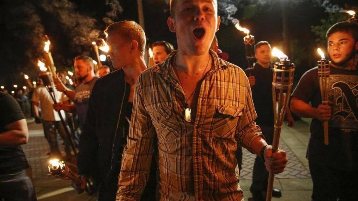 Multiple white nationalist groups march with torches through the UVA campus in Charlottesville, Va. on Aug. 11, 2017.