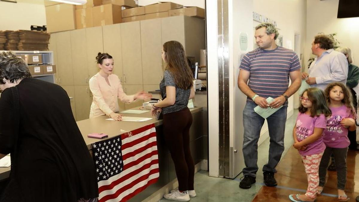 The San Luis Obispo County Clerk-Recorder’s Office was busy in the run up to the Nov. 8 election with a steady stream of voters. Waiting in line is Jason Helfman, of San Luis Obispo, who brought his daughters Sydney, 11, and Macey, 6, to experience the voting process.