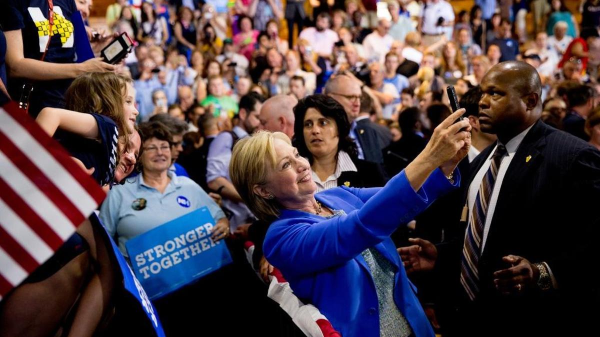 Democratic presidential candidate Hillary Clinton takes a selfie with supporters after being endorsed by Democratic presidential candidate Sen. Bernie Sanders, I-Vermont, at a rally at Portsmouth High School in Portsmouth, New Hampshire, on July 12, 2016.