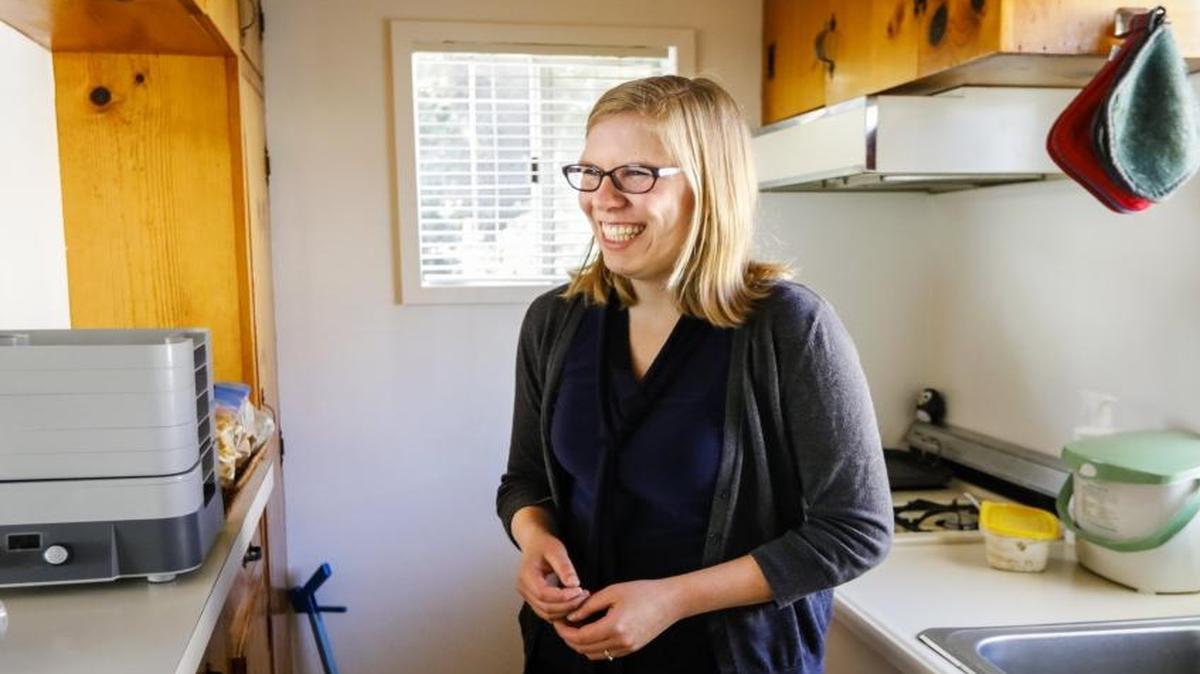 Natalie Marinelli is a Cal Poly grad and former Apple employee in the Bay Area who moved back to SLO County with her husband for the quality of life, but the lack of affordable housing has been an issue for them. Here she stands in the kitchen in the apartment she and her husband rent.
