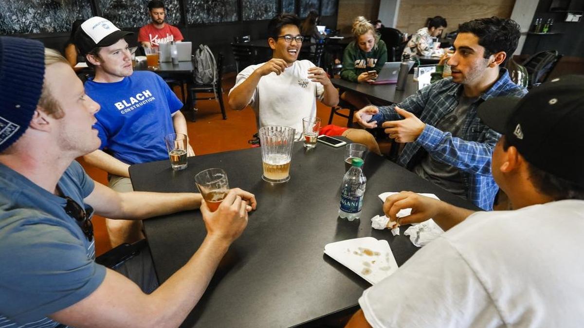 Colin Dzubnar, left, Kenny Kimbrough, Nick Nam, Alex Sargiss and Irl Barajas enjoy some afternoon beers and conversation at Cal Poly’s Mustang Station in October.