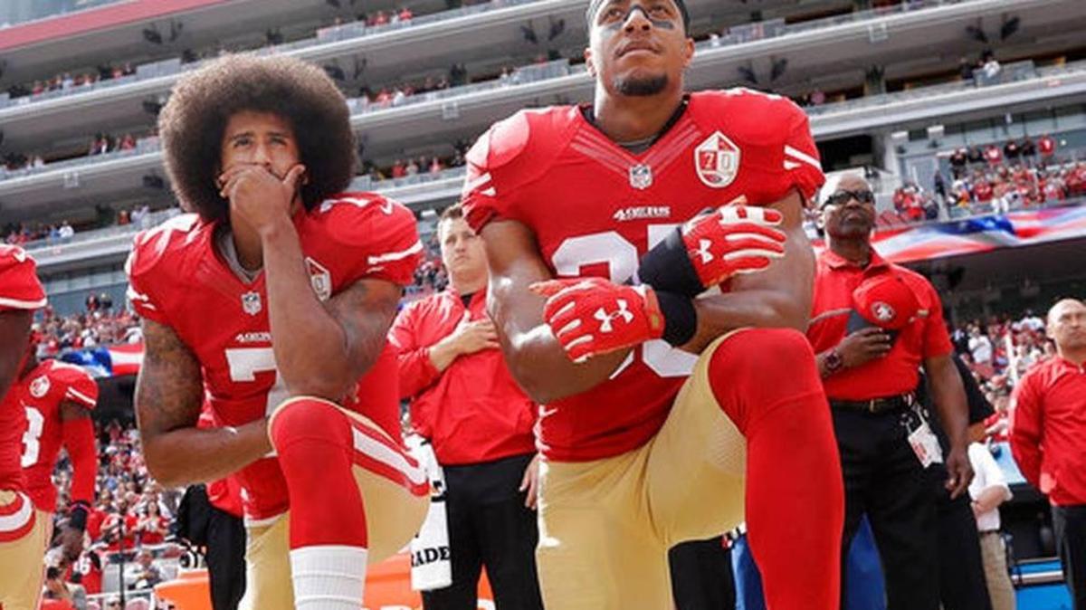 FILE - In this Oct. 2, 2016 file photo, San Francisco quarterback Colin Kaepernick, left, and safety Eric Reid kneel during the national anthem before an NFL football game against the Dallas Cowboys in Santa Clara, Calif.
