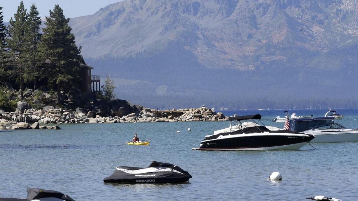 In this 2015 photo, a kayaker paddles along in Lake Tahoe, on the border of California and Nevada. A study says the average surface temperature of Lake Tahoe has risen faster over the past four years than any time on record.