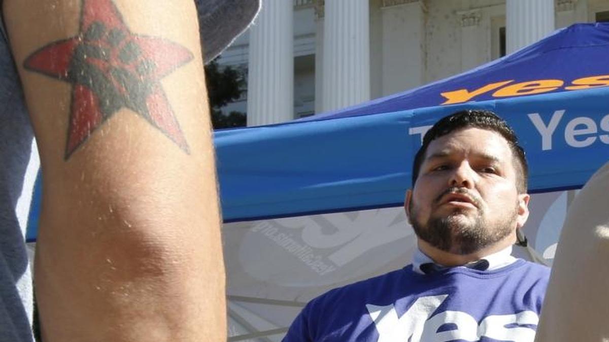 In this Nov. 9, 2016 file photo, Marcus Ruiz Evans, center, of The Yes California Independence Campaign, talks to passersby about California succeeding from the United States and becoming its own nation in Sacramento.