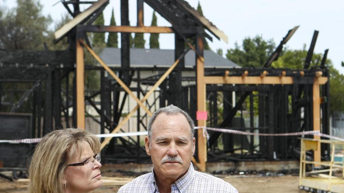 Donna and Greg France, farmers and project owners stand at the scene of Nipomo housing under construction intended for farmworkers. One house was struck by an arsonist, destroying one unit and damaging another.