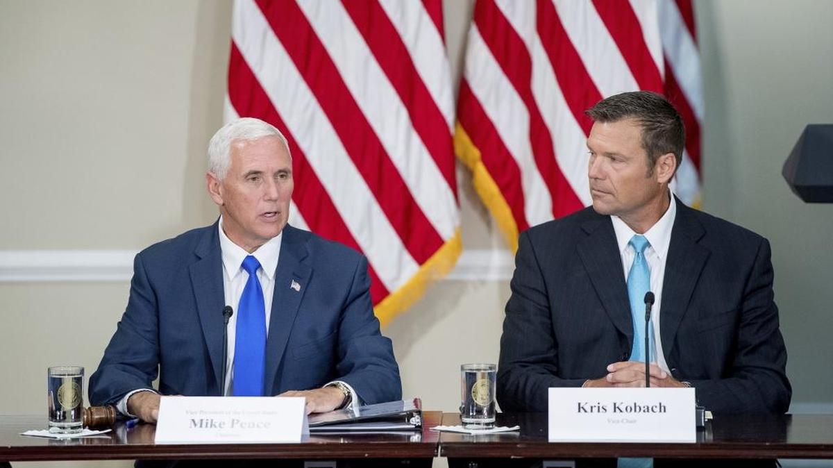 In this Wednesday, July 19, 2017 file photo, Vice President Mike Pence, left, accompanied by Vice-Chair Kansas Secretary of State Kris Kobach, right, speaks during the first meeting of the Presidential Advisory Commission on Election Integrity at the Eisenhower Executive Office Building on the White House complex in Washington.