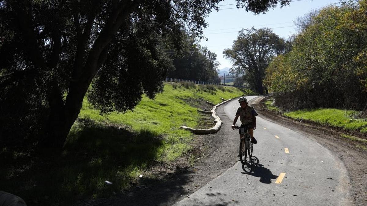 Steven Bangs rides an new bike path along Highway 41 and Atascadero Creek from Portola Road to San Gabriel.
