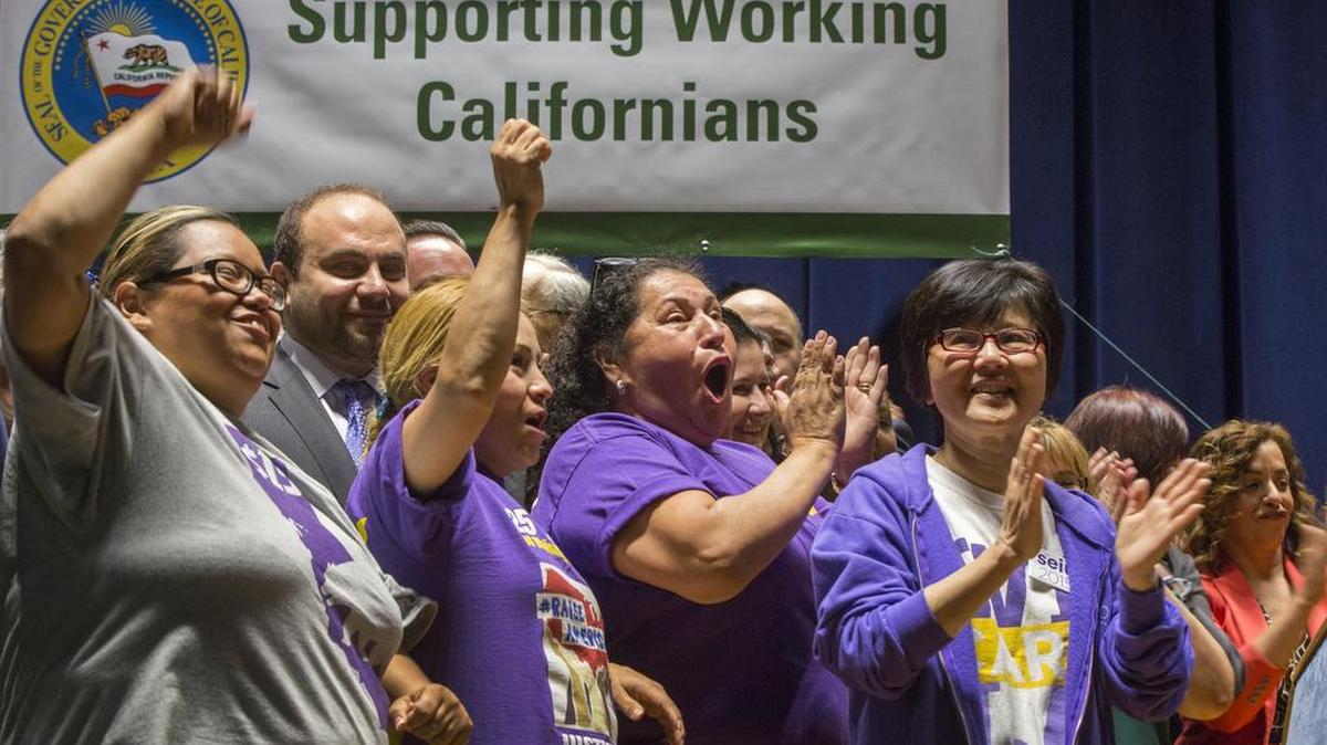 Union workers support Gov. Jerry Brown signing a bill creating the highest statewide minimum wage at $15 an hour by 2022 at the Ronald Reagan building in Los Angeles on April 4. California and New York both acted early April to gradually push their statewide minimum wages to $15 an hour, the highest level in the nation.