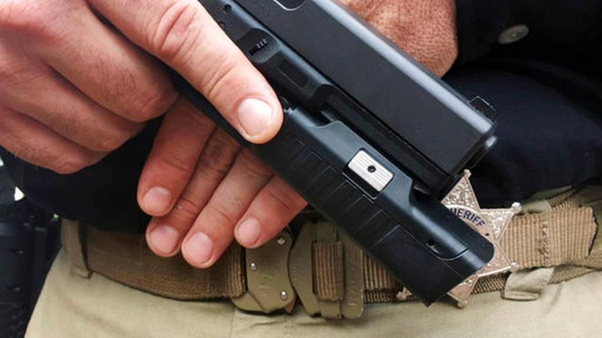 In this Sept. 23, 2017 photo provided by Centinel Solutions, a model displays a camera mounted below the barrel of a handgun in New York. Some police departments are considering putting cameras on officers' guns, saying they would give a better, unobstructed view of police-involved shootings and save money on video storage costs compared with body cameras.