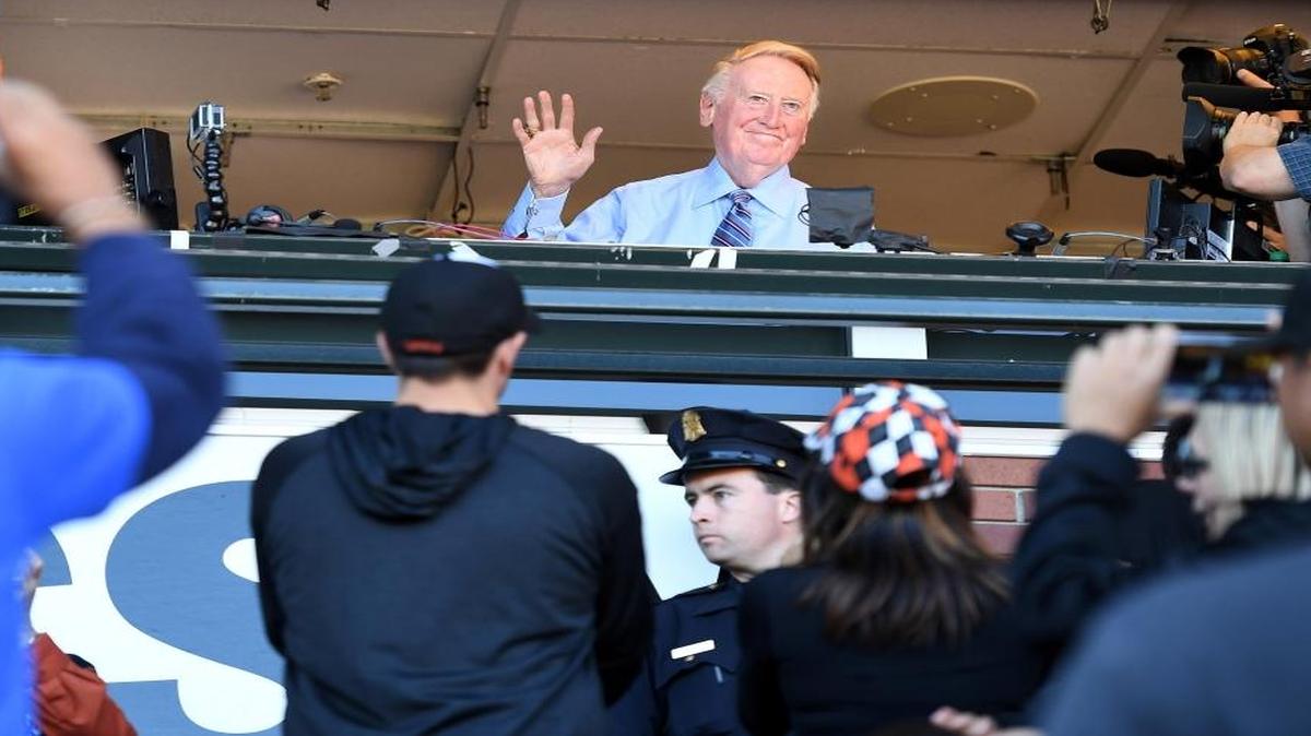 Los Angeles Dodgers broadcast announcer Vin Scully waves to the crowd on Sunday, Oct. 2., while being honored at AT&T Park in San Francisco, Calif.