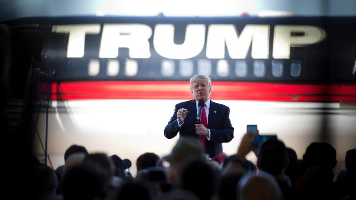 In this Feb. 27, 2016 file photo, then-Republican presidential candidate Donald Trump stands in front of his airplane as he speaks during a rally in Bentonville, Ark.