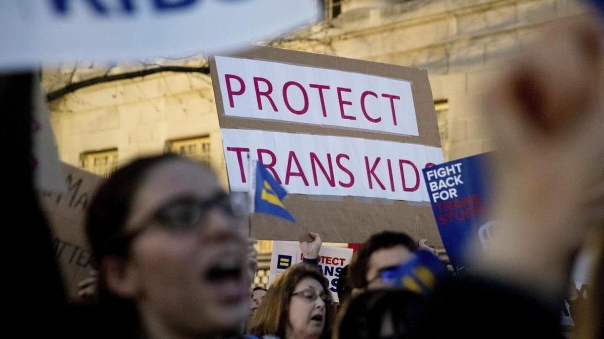 Activists and protesters with the National Center for Transgender Equality rally in front of the White House, Wednesday, Feb. 22, 2017, in Washington, after the Department of Education and the Justice Department announce plans to overturn the school guidance on protecting transgender students.