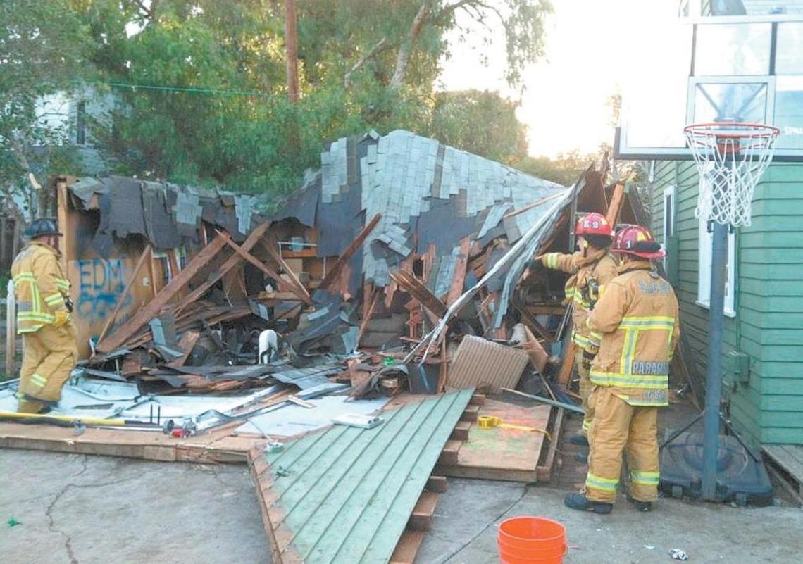 Firefighters look over a collapsed garage at 348 Hathway Ave. after a St. Fratty’s Day party in 2015.