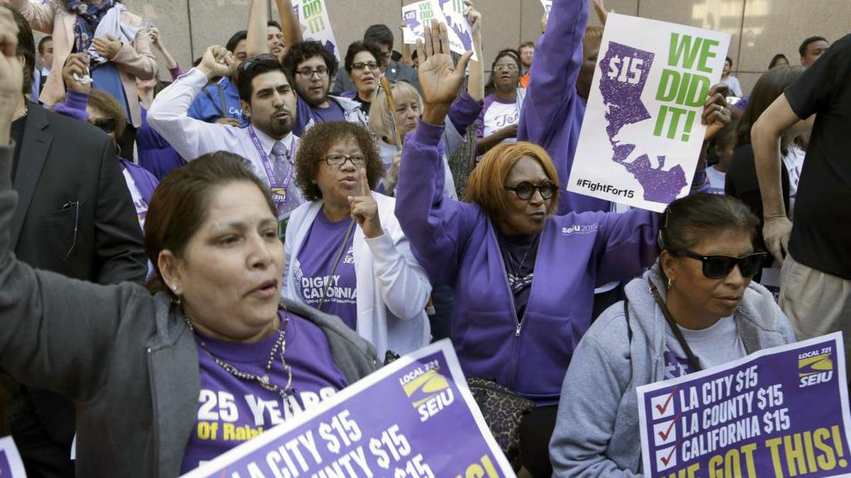 Workers rally outside the Ronald Reagan State Building in Los Angeles after California’s Gov. Jerry Brown signed a bill creating highest statewide minimum wage at $15 an hour by 2022 in Los Angeles on Monday. California and New York acted Monday to gradually push their statewide minimum wages to $15 an hour, the highest level in the nation.