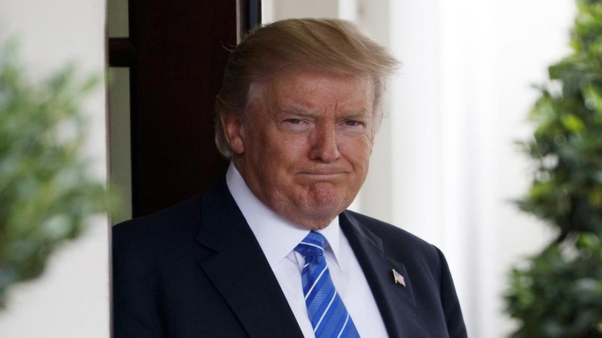 President Donald Trump waits outside the West Wing of the White House for the arrival of Malaysian Prime Minister Najib Razak, Tuesday, Sept. 12, 2017, in Washington.