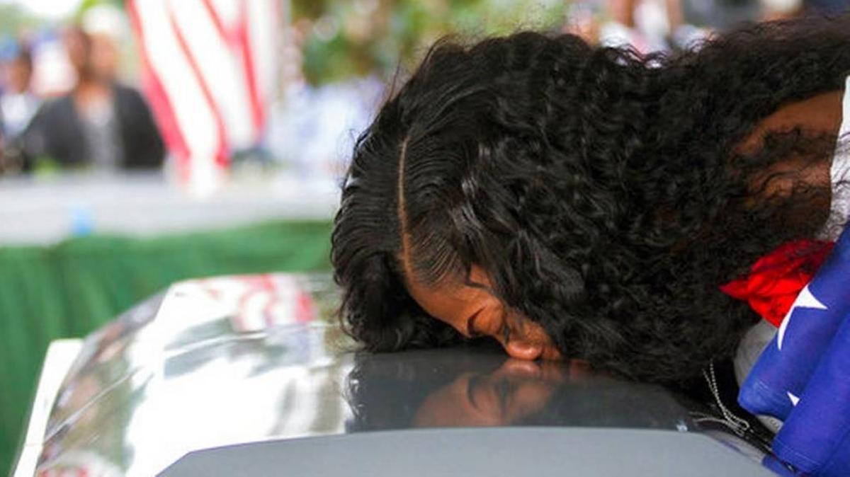 In this Saturday, Oct. 21, 2017, file photo, Myeshia Johnson kisses the casket of her husband, Sgt. La David Johnson during his burial service at Fred Hunter's Hollywood Memorial Gardens in Hollywood, Fla. Myeshia Johnson told ABC's "Good Morning America" on Monday, Oct. 23, 2017, that she has nothing to say to the president, adding that his phone call to her made "me cry even worse."