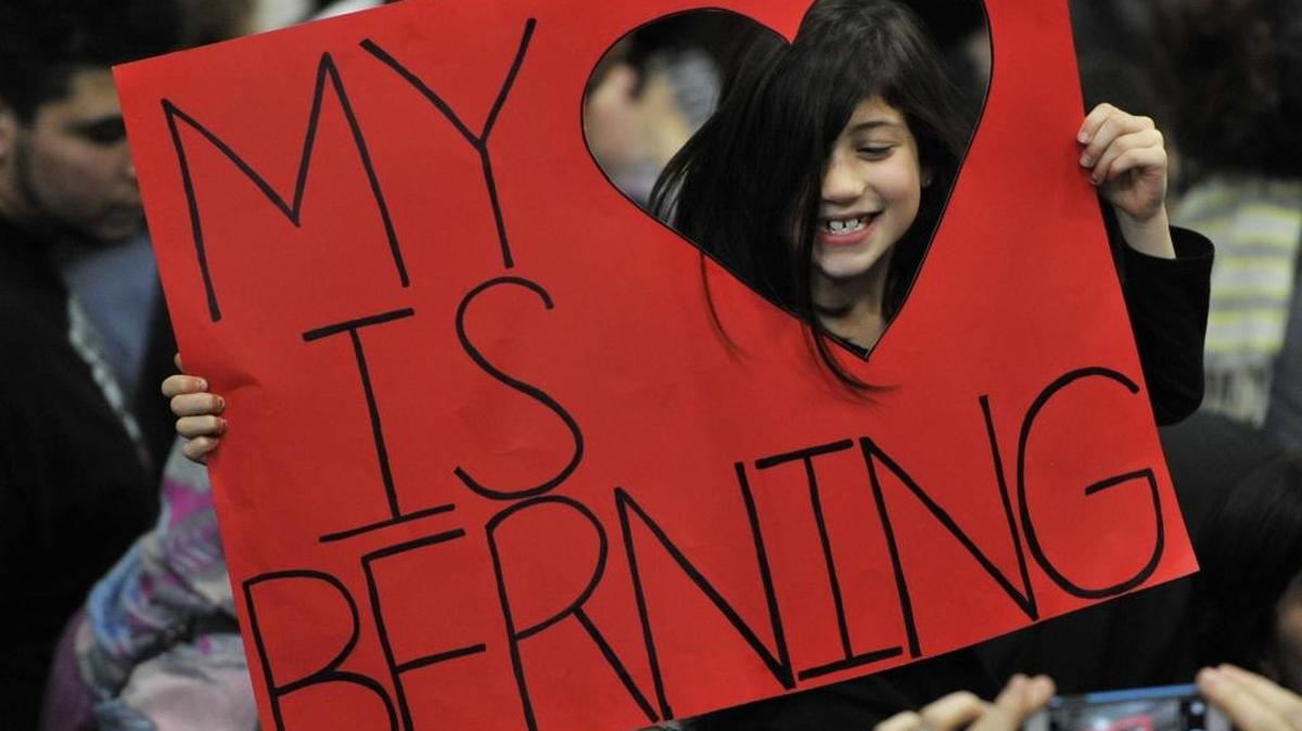Supporter Allegra Feverstein, 7, of Brookfield Ill., poses for a photo before Democratic presidential candidate Sen. Bernie Sanders, I-Vt., spoke during a rally Friday, March 11, 2016, in Summit, Ill.