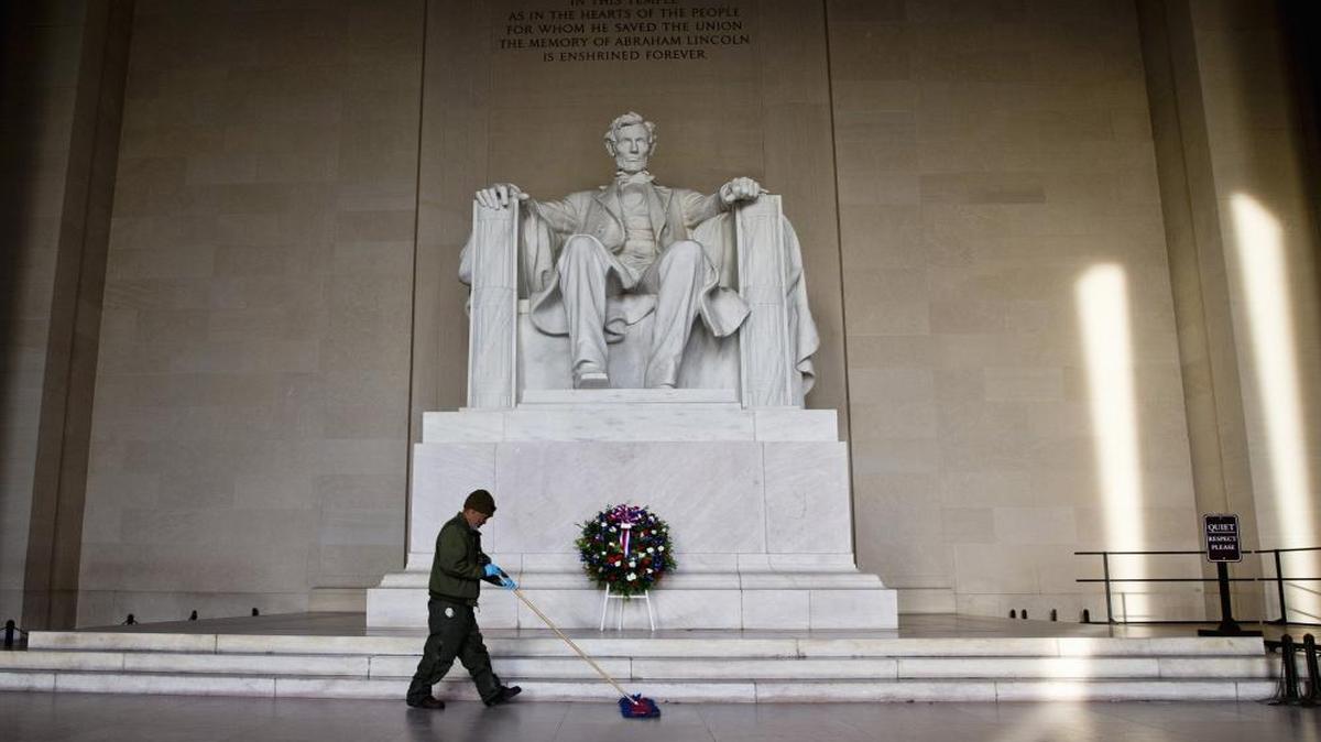 Ronald Price, with the U.S. Park Service, sweeps up after the U.S. military conducted a Presidential Full Honor Wreath-Laying Ceremony in celebration of the 207th birthday of President Abraham Lincoln, Friday, Feb. 12, 2016, at the Lincoln Memorial in Washington.