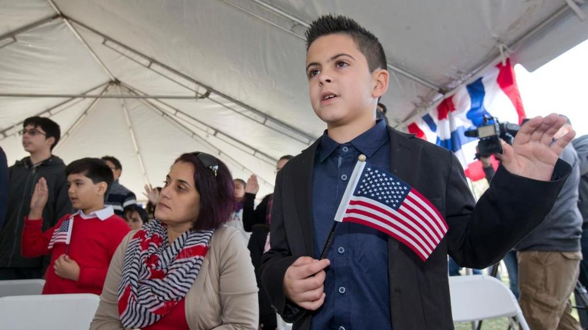 Jerlys Paneca, 9, of Cuba, takes the Oath of Allegiance during a U.S. Citizenship and Immigration Services naturalization ceremony, Friday, Jan. 19, 2018, in Biscayne National Park, Fla. Paneca was one of 83 children from 17 countries to become American citizens during the ceremony.