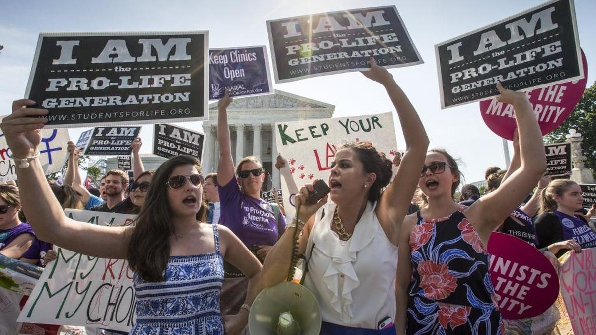 Reagan Barklage of St. Louis, center, and other anti-abortion activists demonstrate in front of the Supreme Court in Washington, Monday, June 27, 2016, as the justices struck down the strict Texas anti-abortion restriction law known as HB2.