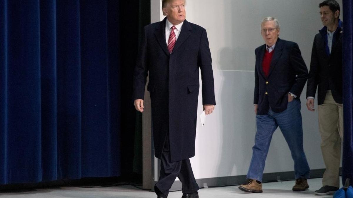 President Donald Trump, left, accompanied by Senate Majority Leader Mitch McConnell of Ky., second from right, and House Speaker Paul Ryan of Wis., right, arrives for a news conference after participating in a Congressional Republican Leadership Retreat at Camp David, Md., Saturday, Jan. 6, 2018.
