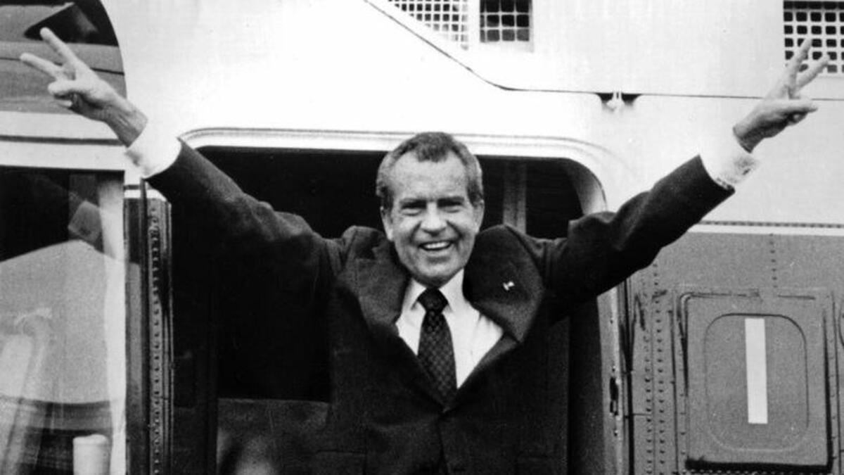In this Aug. 9, 1974 file photo, Richard Nixon waves goodbye with a salute to his staff members outside the White House as he boards a helicopter and e resigns the presidency on Aug. 9, 1974. He was the first president in American history to resign the nation's highest office.
