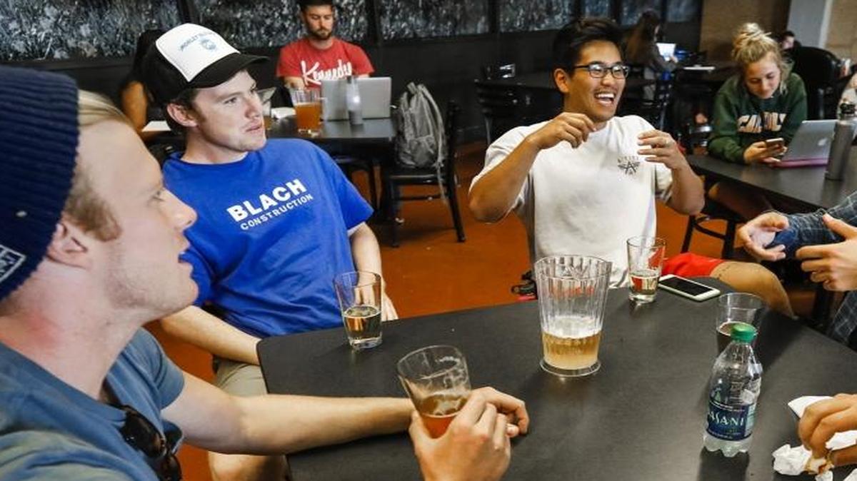 Colin Dzubnar, left, Kenny Kimbrough, Nick Nam, Alex Sargiss and Irl Barajas enjoy some afternoon beers and conversation at Cal Poly’s Mustang Station in October.