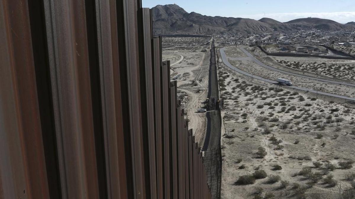 A truck drives near the Mexico-US border fence, on the Mexican side, separating the towns of Anapra, Mexico, and Sunland Park, New Mexico, on Jan. 25, 2017.